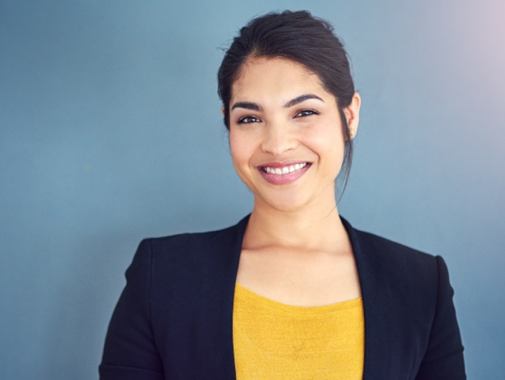 Young professional woman in a blazer and yellow sweater