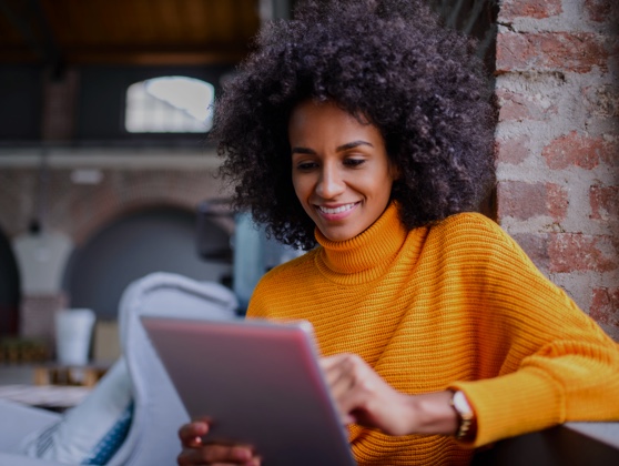 Young woman using an iPad to book an appointment online