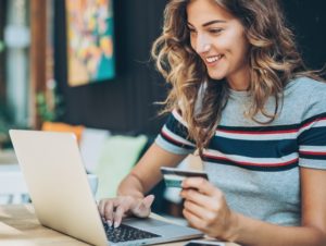 Young woman shopping online with a laptop