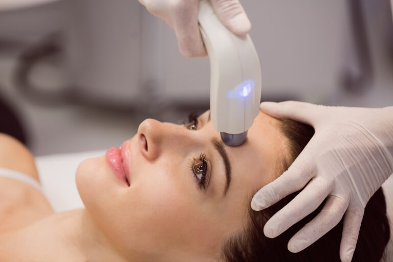 Beautiful woman receiving a MOXI Laser treatment at Ageless Remedies of Roswell clinic, demonstrating skin rejuvenation benefits of MOXI Laser and BroadBand Light Therapy.