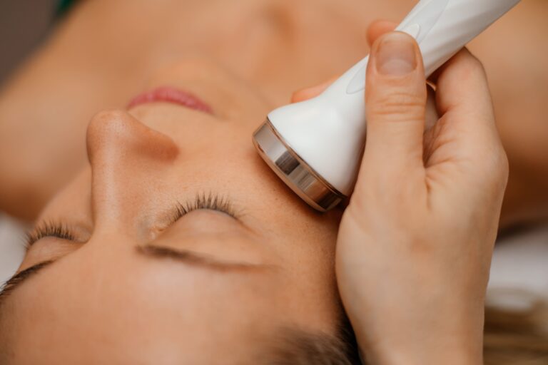 A close-up of a woman receiving a laser facial treatment with a handheld device, demonstrating the precision and rejuvenating effects of the best laser facial treatment for smoother, healthier skin.