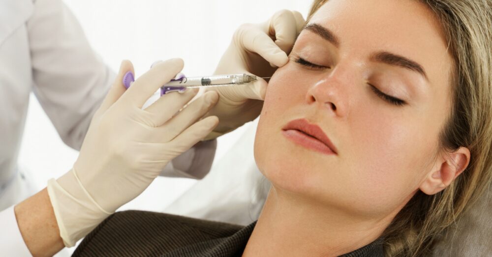 A woman with a fresh, youthful appearance receiving facial treatment